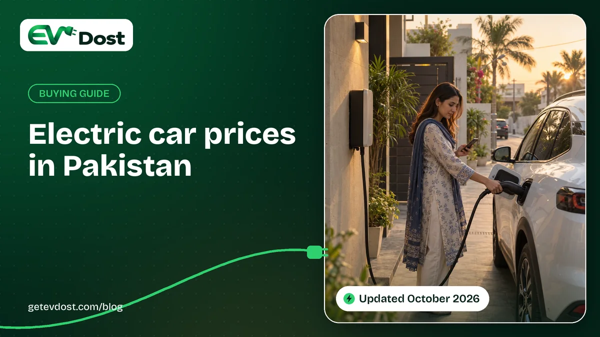 A woman plugs a charging cable into her white car outside her home at golden hour