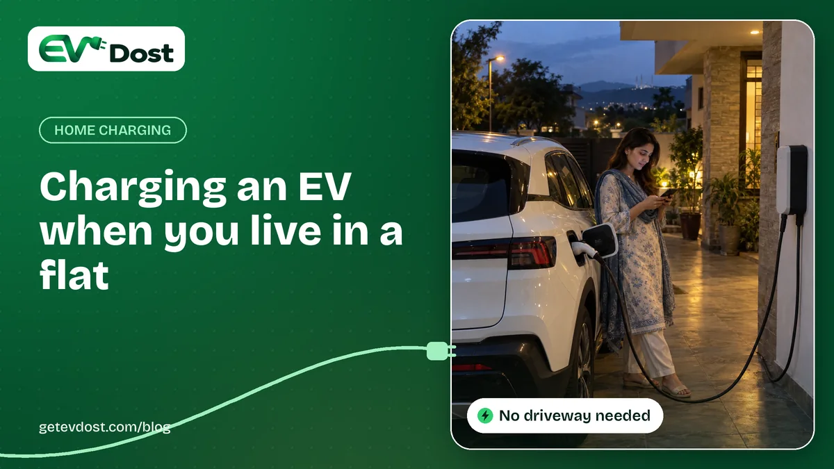 A woman looks at her phone while her car charges outside a home at dusk